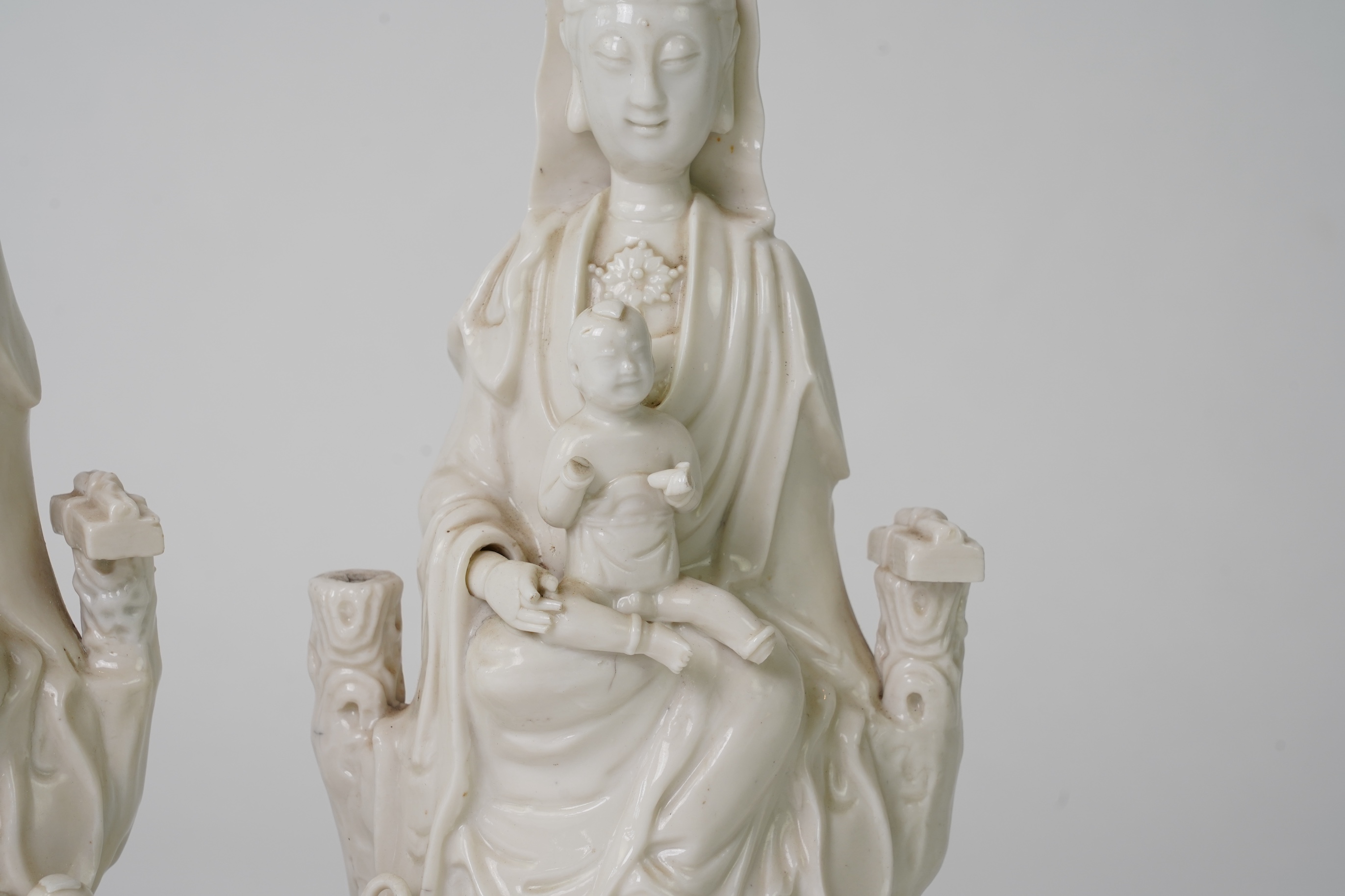 A pair of Chinese blanc de chine groups of Guanyin and children, 18th century